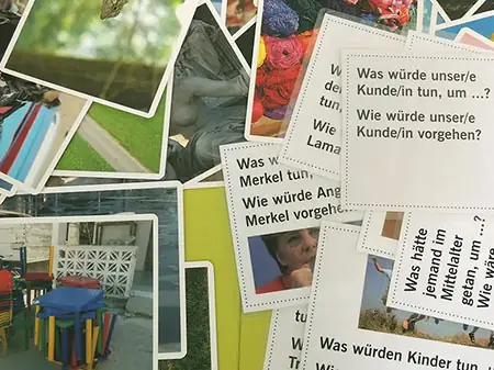 Bild-Karten und Karten mit Inspirations-Fragen aufgefächert im Visions Workshop
